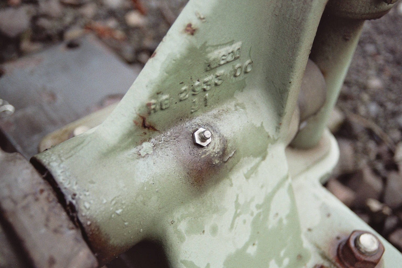 Close-up of a grease fitting installed on a bearing in a railway point lever mechanism